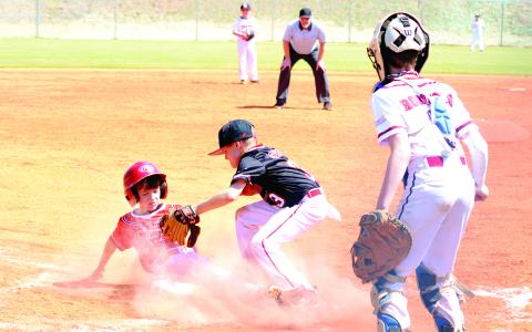 This runner beats the tag at home plate by an eyelash during one of the inaugural games at Morgan County’s new recreational complex. T. MICHAEL STONE/Staff