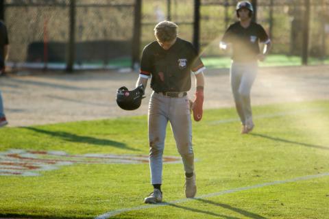 Morgan County's Cole Wesley walks off the diamond after being tagged out on a force play at second base during the first inning of game three. LANCE MCCURLEY/Staff