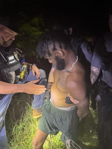 A Morgan County investigator secures suspect Daquan Unique Davis. CONTRIBUTED