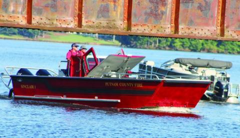 Putnam County Fire Department’s personnel scan the lake from “Sinclair 1” searching Lake Sinclair with other agencies for the missing jet ski rider. LYNN HOBBS/Staff