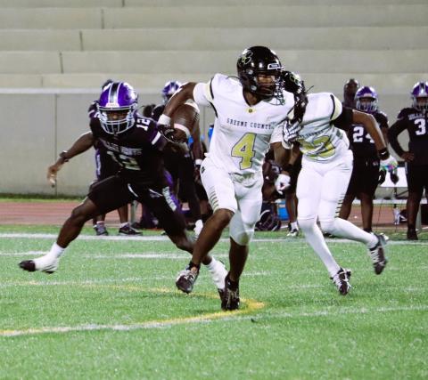 Greene County ball carrier Dontriel Grable (4) totes the ball past Miller Grove’s front seven. Courtesy of Momma D’s Pix