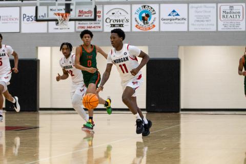 Morgan County senior guard Zeki Locus (11) pushes the ball up the floor in transition. He scored 23 points and grabbed 24 rebounds in the region championship win over Rutland. SKYLA MORRIS/Staff