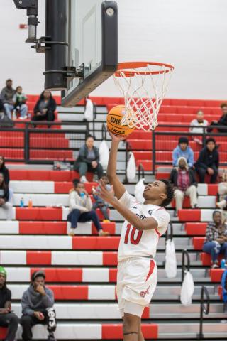 Morgan County sophomore Dreylon Brown (10) goes up for a layup in the Dogs' dominant win over Coahulla Creek. SKLYA MORRIS/Staff