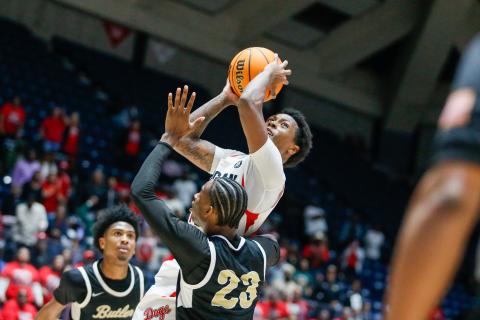 Morgan County senior point guard Zeki Locus goes up for a layup over a Butler defender. LANCE McCURLEY/Staff