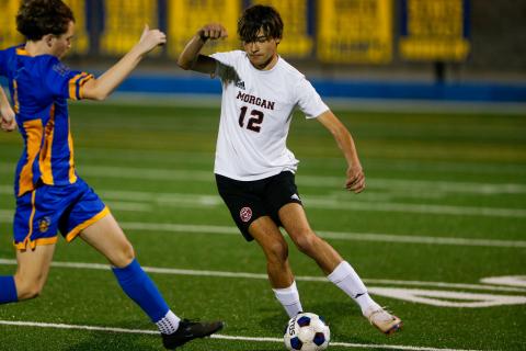 Senior Rob Bennett (12) dribbles the ball past a defender. LANCE McCURLEY/Staff