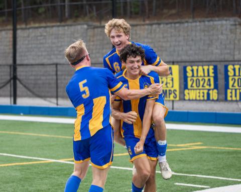 LOA seniors Austin Dell (5) and Garrett Griffin (6) celebrate with sophomore teammate Poli Medrano (15) after he scored the game-winning goal against Echols County on April 29, sending the defending state champion Titans back to the Elite Eight. SKYLA MORRIS/Staff