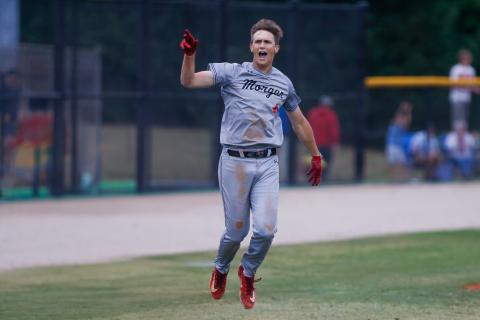Morgan County senior Davis Strickland rounds third base, tosses his helmet into the air and celebrates after hitting a game-winning grand slam against Stephens County, securing an Elite Eight berth for the Bulldogs. LANCE MCCURLEY/Staff