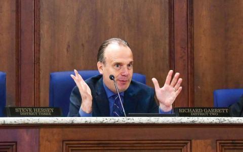 District 2 Commissioner Richard Garrett makes a point during the Aug. 7 meeting, with District 3’s Steve Hersey (left) and Tom McElhenney of District 1 listening. District 4 Commissioner Jeff Wooten was absent. IAN TOCHER/Staff