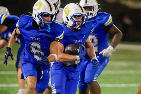 LOA running back Griffin Stanford carries the ball downfield behind his blockers during a scrimmage Aug. 7. LANCE McCURLEY/Staff