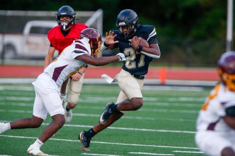 Greene County running back Johnathan Lawrence (27) prepares to stiff-arm a Hancock Central defender during last week’s scrimmage. LANCE McCURLEY/Staff