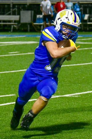 LOA running back Alden Barreras powers through the Mount Pisgah defense for a first down during Friday’s season opener. IAN TOCHER/Staff