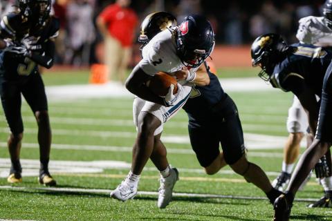 Putnam County junior running back Kumari Thomas (2) shrugs off a Greene County defender as he crosses the goal line for his second touchdown of the game. LANCE MCCURLEY/Staff