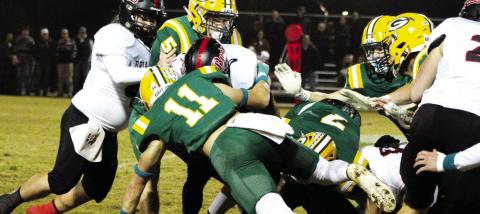 Mason Sinclair (11) makes the stop on a Briarwood ball carrier, aided by seniors Blake Callaway (5) and Evan Bennett (7). ARELLA CASH/Staff