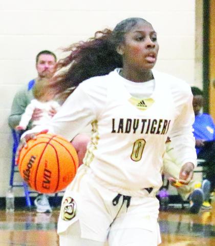 Greene County's Jesaria Porter (0) brings the ball up the floor in a recent region tournament game against Washington-Wilkes. LANCE MCCURLEY/Staff