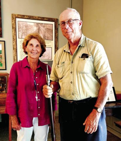 Retired judge LaVerne Ogletree and Bill Adams with a Civil War-era rifle. CONTRIBUTED