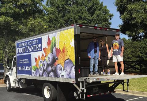 L-R: Greene County Food Pantry Chairman Steve Ruzika, Michelle Perry, and Rick Perry took part in organizing item donations during the Tuesday morning event. CONTRIBUTED