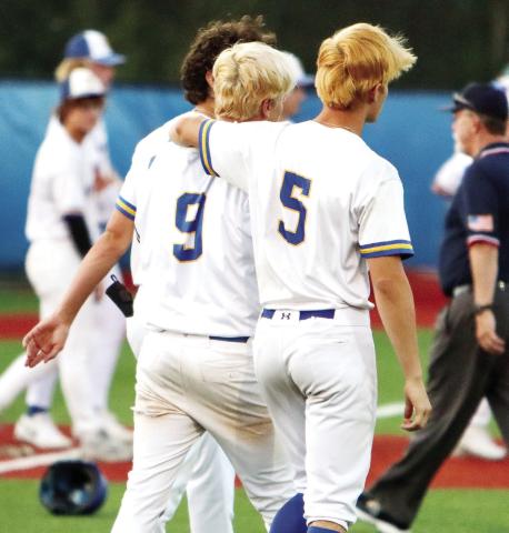 Lake Oconee Academy’s Ian Watson (9) and Dylan Hiter (5) walk off the field following game two’s loss to Charlton County last Friday. (LANCE McCURLEY/Staff)