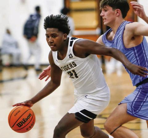 Greene County guard Qua Williams (21) dribbles past a Towns County defender in transition in a win over the Indians on Jan. 13. LANCE McCURLEY/Staff