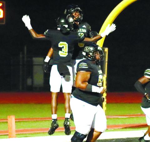 BJ Mullens (3) jumping up and celebrating with fellow wide receiver Quay Burdette after he found the end zone in the first half. BRENDAN KOERNER/Staff