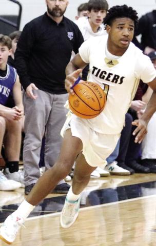 Greene County junior Steve Miller (1) rushes the ball up the floor in an attempt to give the Tigers the lead over Towns County at the end of regulation. LANCE MCCURLEY/Staff