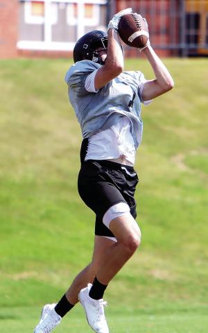 Morgan County wide receiver Ty Tillery makes a catch in midair during a padded camp in July. Tillery will be one of the pass catchers the Bulldogs’ offensive attack will rely on this year. LANCE McCURLEY/Staff