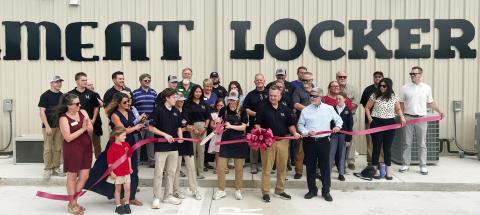 Lisa Simmons, co-owner of The Meat Locker with her husband Darin beside her, makes the official ribbon cut April 4 with Eatonton-Putnam Chamber of Commerce President Robbie King (in sunglasses) looking on. IAN TOCHER/Staff