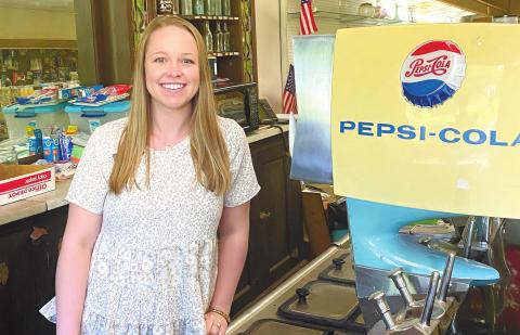Union Pharmacy owner Pharmacist Liddy Cronan in front of the circa 1940s era soda fountain at the pharmacy she owns. MAUREEN STRATTON/Staff