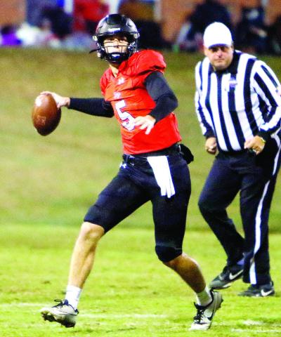 Morgan County quarterback Davis Strickland (5) completed 26 of 35 passes for 338 yards and four touchdowns in the loss t o Rockmart last Friday. LANCE McCURLEY/Staff