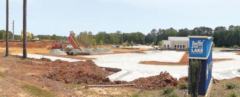 The Lake Oconee Church on Highway 44 is expanding its parking (foreground) and constructing a new building (center, distant) to hold services and classes. A Dunkin’ donut store is being built on the corner (far left). MARK ENGEL/Staff