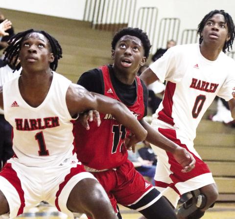 Harlem's Kee Williams (1) and Braylon Bussey (0) box out Morgan County's Jay Elder during a free-throw attempt. LANCE MCCURLEY/Staff