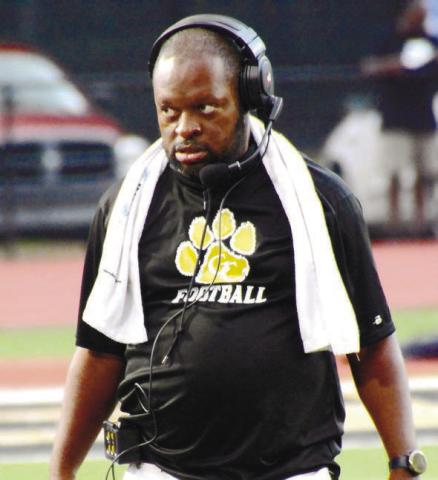 Greene County head coach Terrance Banks looks to his players on the sideline before their scrimmage game against Putnam County. BRENDAN KOERNER/Staff