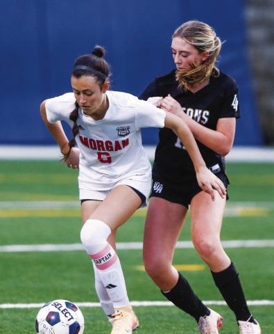 Morgan County senior Molly Makaitas (6) tries to dribble the ball away from a Lake Oconee Academy defender during a 5-0 win over the Lady Titans on Tuesday. LANCE McCURLEY/Staff