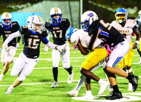 An LOA defensive lineman attempts to bring down a Warren County ball carrier in last Friday’s region matchup. SKYLA MORRIS/Staff