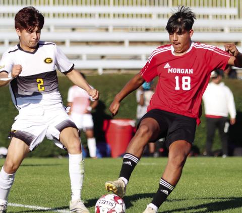 Morgan County midfielder Julian Tenorio (18) tries to dribble the ball away from a Groves defender in last season’s first-round playoff win. He will be a huge part of the Dogs’ success in 2024. LANCE McCURLEY/Staff