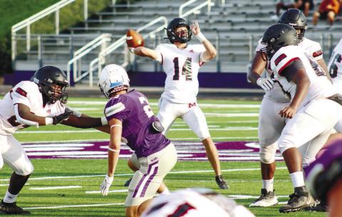 Morgan County quarterback Talan Fuller (14) gets set to deliver a pass downfield to an open wide receiver against the Bears last Tuesday. LANCE McCURLEY/Staff