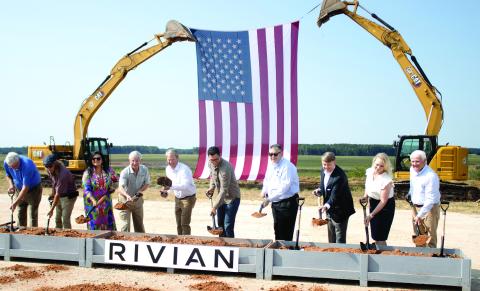 Rivian founder and CEO RJ Scaringe (third form left), with Georgia Gov. Brian Kemp to the right, helps break ground on the Stanton Springs project site in Social Circle, alongside several other state and local representatives. SKYLA MORRIS/Staff