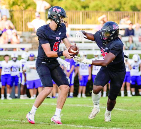 Morgan County quarterback Davis Strickland hands the ball off to running back Christian Monfort during a scrimmage against Cherokee Bluff on Aug. 7. SKYLA MORRIS/Staff