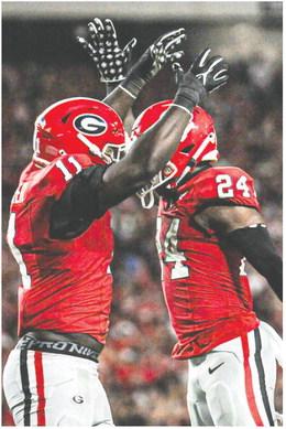 Sophomore linebacker Jalon Walker (11) and defensive back Malaki Starks celebrate during the win over UAB at Sanford Stadium. CHARLES JORDAN/Contributed