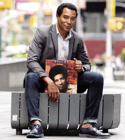 Singer Charl Brown poses on a New York street with one of Smokey Robinson’s record albums. CONTRIBUTED