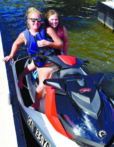 Shannon and Brooklyn Phillips are all smiles upon their return to Oconee Springs Park from a jet-ski ride.