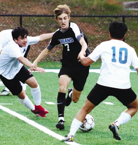 Sophomore winger Palmer Larkin (7) cuts back inside trying to out-dribble a defender during last Friday’s game against Washington-Wilkes. BRENDAN KOERNER/Staff