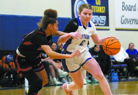 Lake Oconee Academy guard Ansleigh Padgett (2) drives the lane past a Charlton County defender in last week’s first-round playoff loss to the Maidens. TREY NORRIS/Staff