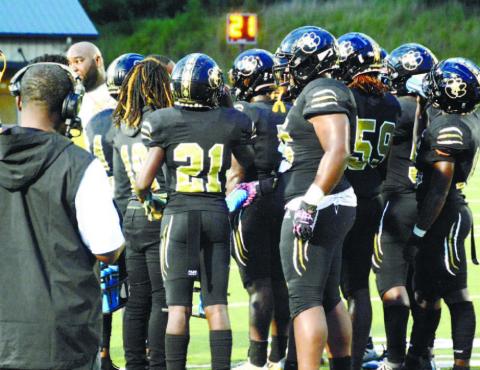 Greene County’s offense huddles up after head coach Terrance Banks calls a time out. BRENDAN KOERNER/Staff