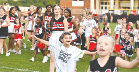 Morgan County youth football cheerleaders celebrate as confetti flies in the air. LANCE MCCURLEY/Staff