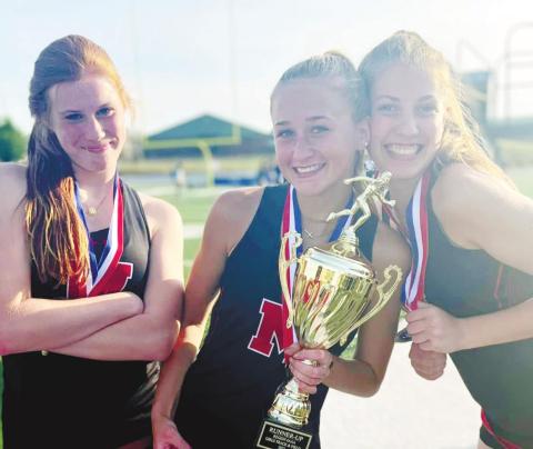 Members of the Lady Dogs’ track team pose with a trophy. CONTRIBUTED