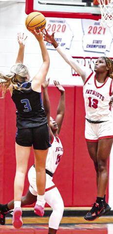 Lady Titans senior Georgia Bosart (3) tries to shoot a jump over an Oglethorpe County defender. CHARLES JORDAN/Staff