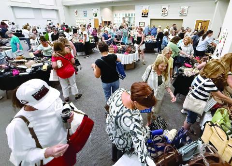 Women dominated the crowd at Upscale Resale, where donated, gently used, high-end pieces of jewelry, purses and carryalls, some clothing, and even a collection of fine jewelry was available for purchase to support local food pantries. IAN TOCHER/Staff