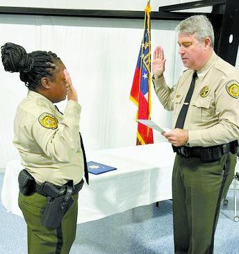 Sheriff Donnie Harrison delivers the Oath of Office to new patrol deputy Quin’sha Goss. CONTRIBUTED