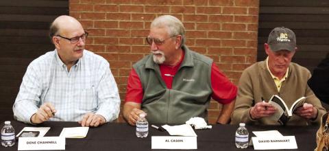 (From L to R): Dene Channell, Al Cason, and David Barnhart, who were all members of the 1970 Greene County High School football team, get set to sign books at the ceremony.