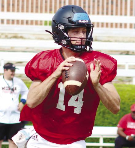 Morgan County rising senior quarterback Talan Fuller (14) rolls out of the pocket and attempts a pass during a practice last week. LANCE McCURLEY/Staff